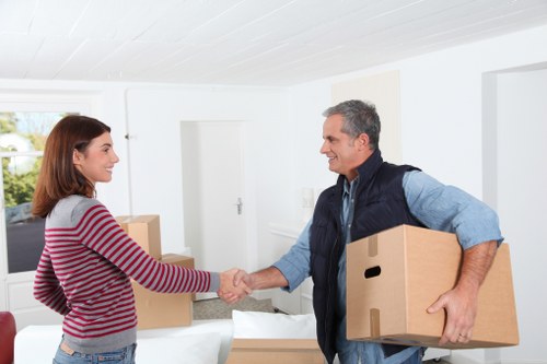 Professional moving truck loading boxes and furniture in Kilburn