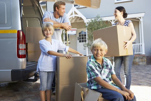 Loading furniture and boxes into a van for a Kilburn removal job