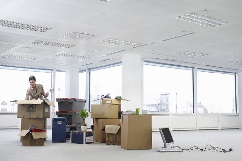 Packed moving boxes and furniture prepared for transport in Kilburn
